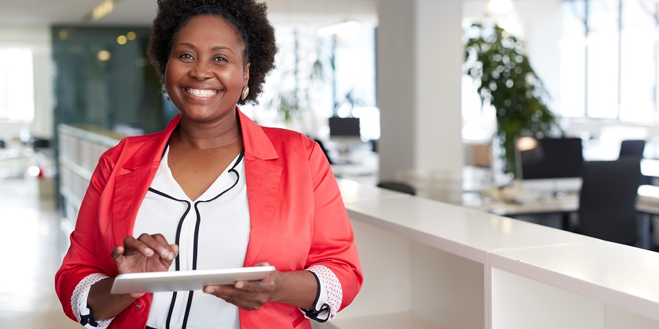 Woman smiling at camera on tablet